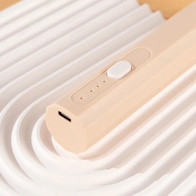 Handheld USB rechargeable electric whisk in apricot colour with mixing attachment