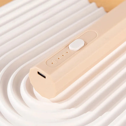 Handheld USB rechargeable electric whisk in apricot colour with mixing attachment
