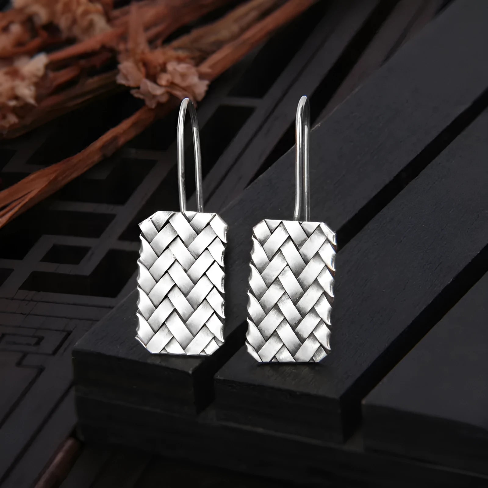 Pair of 925 silver geometric stud earrings with a woven diamond plaid texture on a white background.