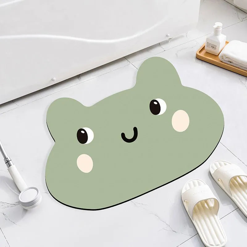Alien-shaped diatomaceous earth bathroom mat with a cartoon hippo design on a tiled floor.