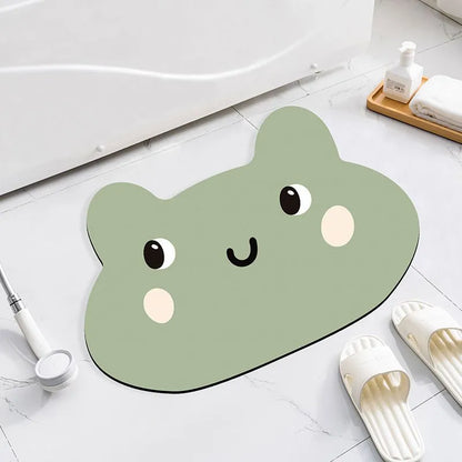 Alien-shaped diatomaceous earth bathroom mat with a cartoon hippo design on a tiled floor.