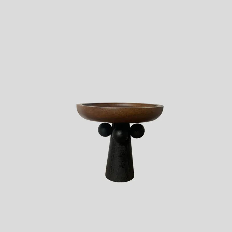 Round beech wood tray with high legs for candles and aromatherapy accessories on wooden table
