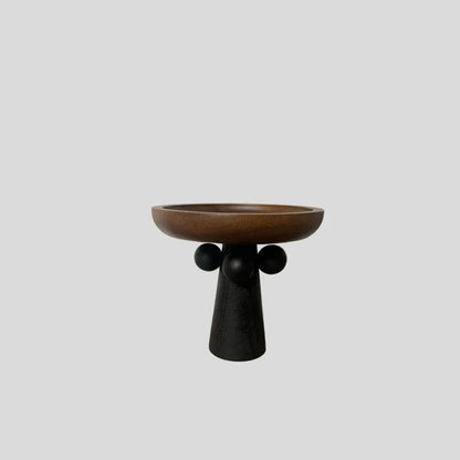 Round beech wood tray with high legs for candles and aromatherapy accessories on wooden table