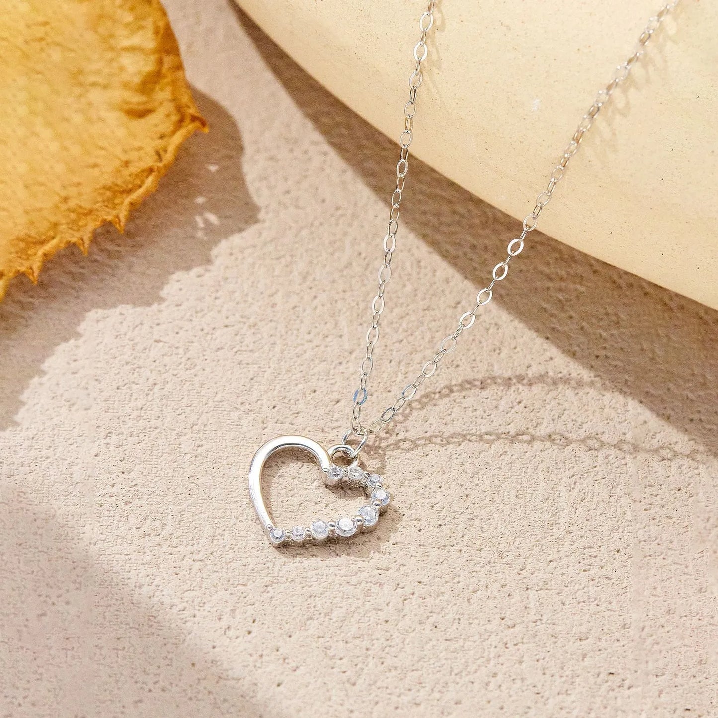 S925 sterling silver hollow heart necklace on a regular chain, available in gold or platinum plating.