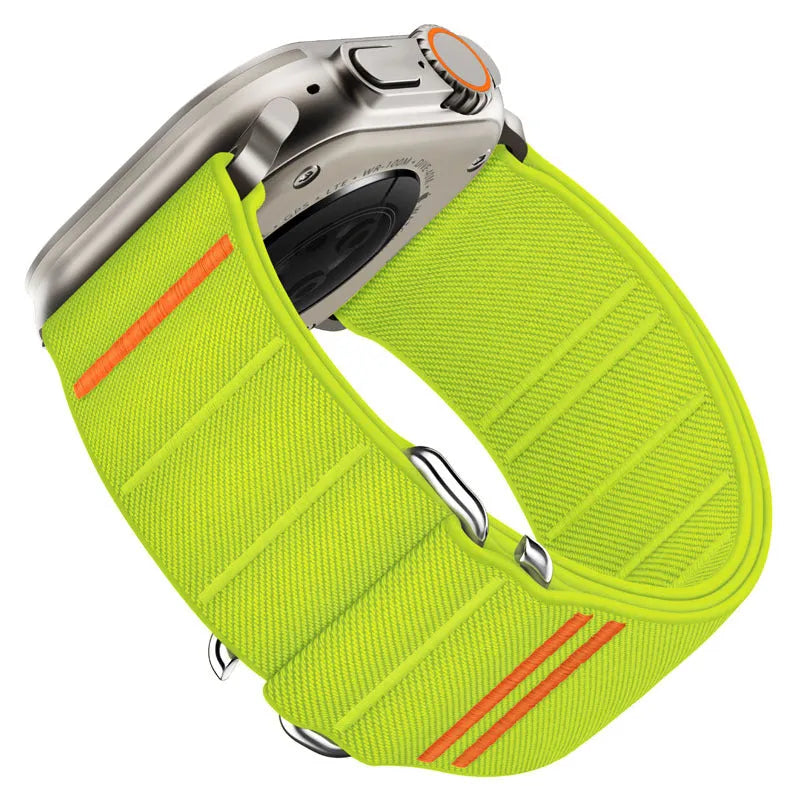 Elastic nylon Apple Watch band with stainless steel buckle shown in Army Green colour on a wrist.