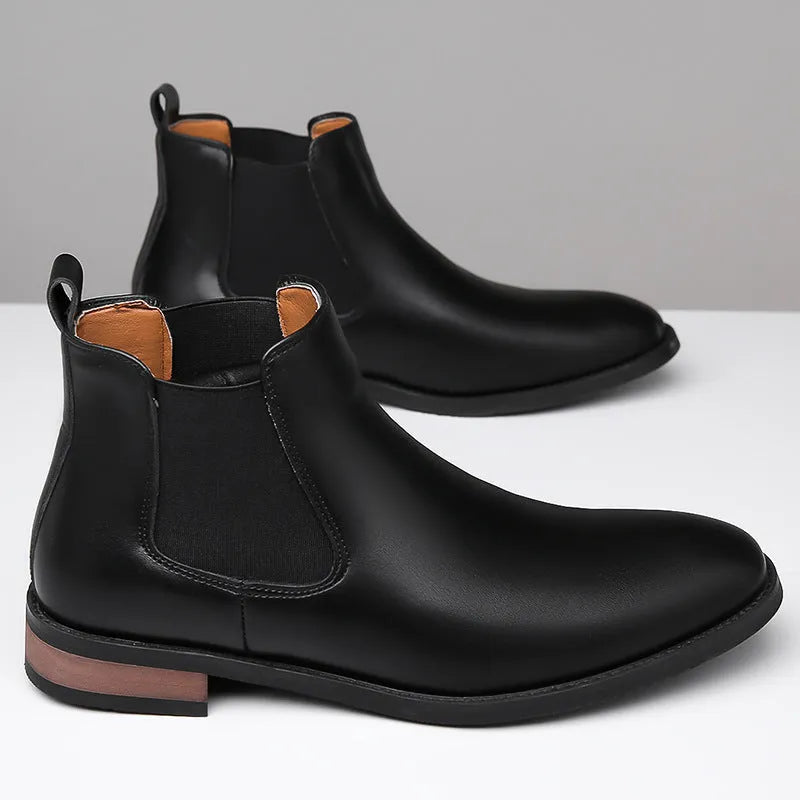 Men's black Chelsea boots with pointed toe design and sewing thread detailing on artificial PU upper