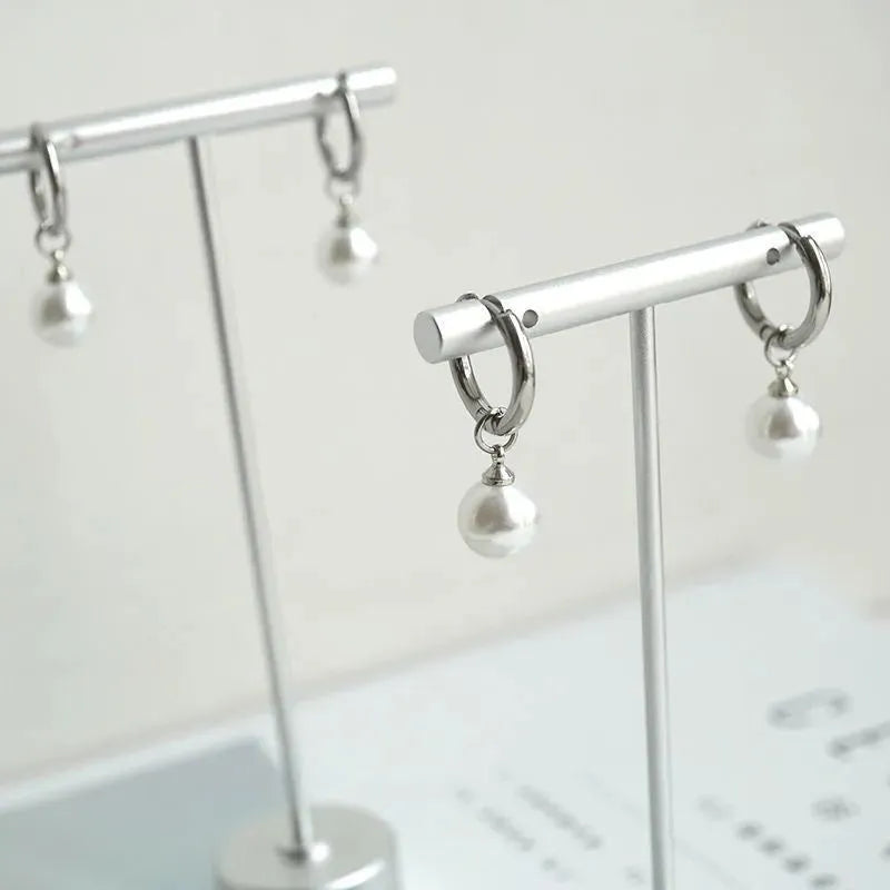 Women's geometric pearl drop earrings with titanium steel posts and round design elements