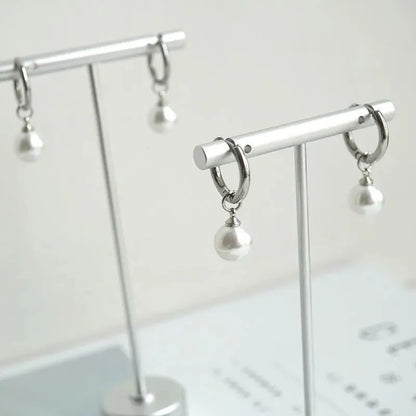 Women's geometric pearl drop earrings with titanium steel posts and round design elements