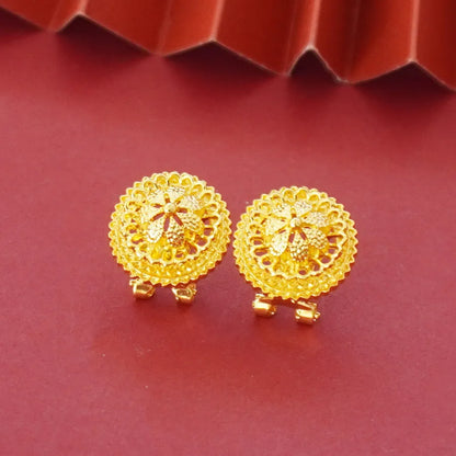 Gold-plated three-piece jewellery set showing necklace with floral pendant, matching earrings, and ring on a grey background.