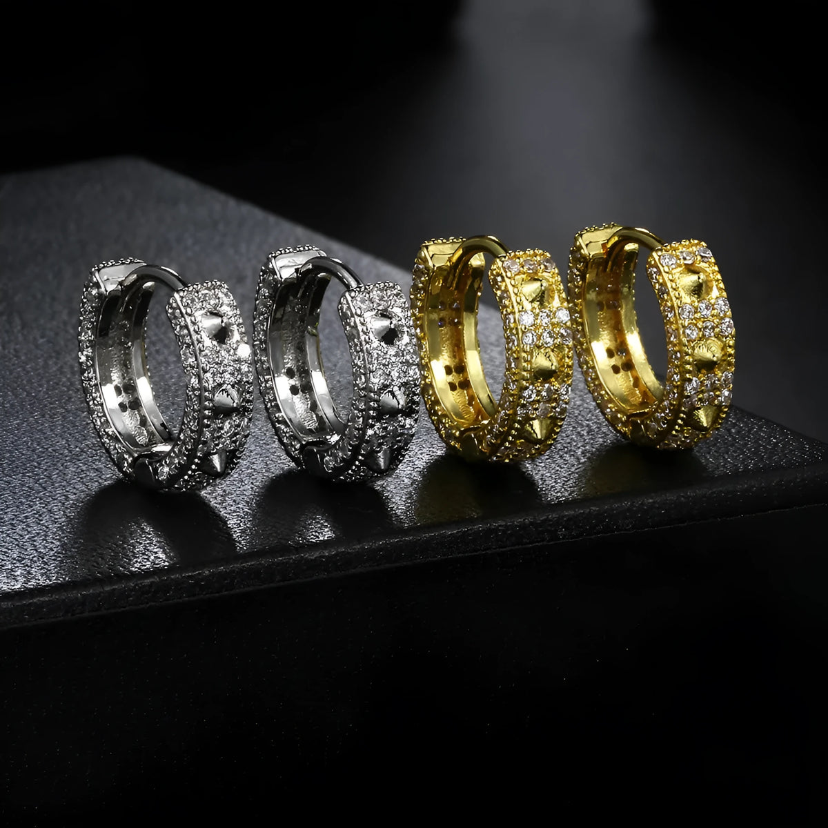 Geometric round hip hop ear clips in white gold stone colour on copper, shown as a pair.