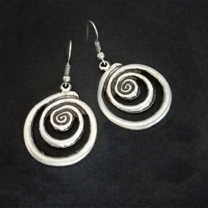 Retro geometric spiral earrings with a distressed silver finish.