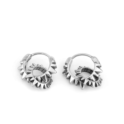 A pair of polished steel colour round hoop earrings on a plain background, showing their seamless ring design.