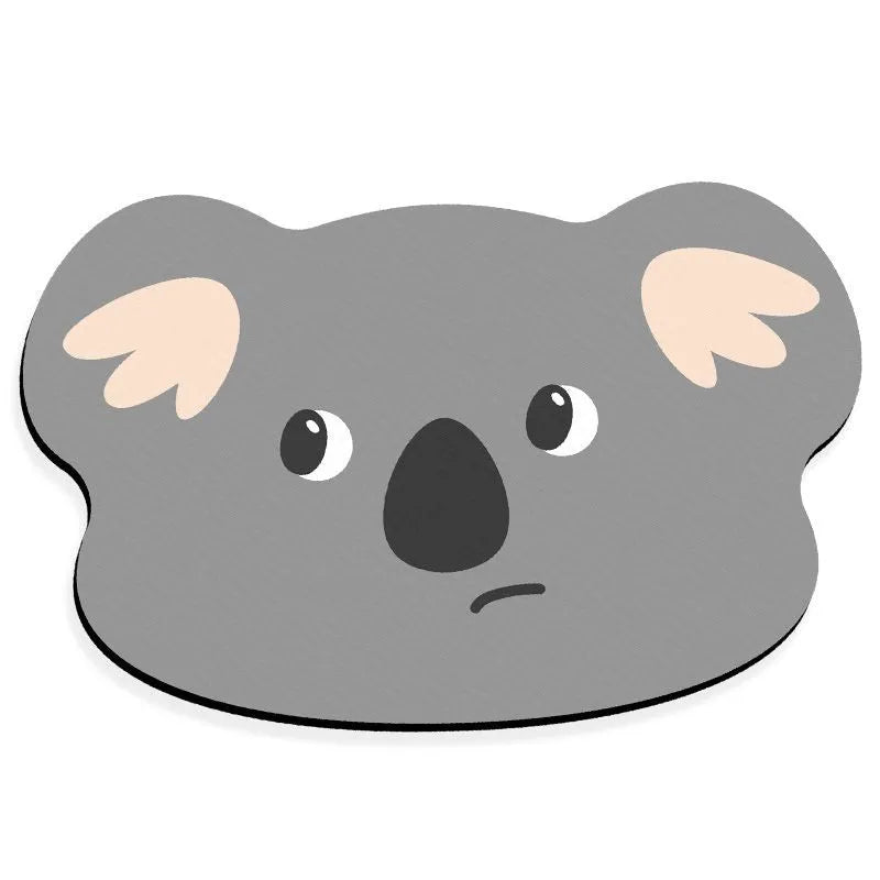 Alien-shaped diatomaceous earth bathroom mat with a cartoon hippo design on a tiled floor.