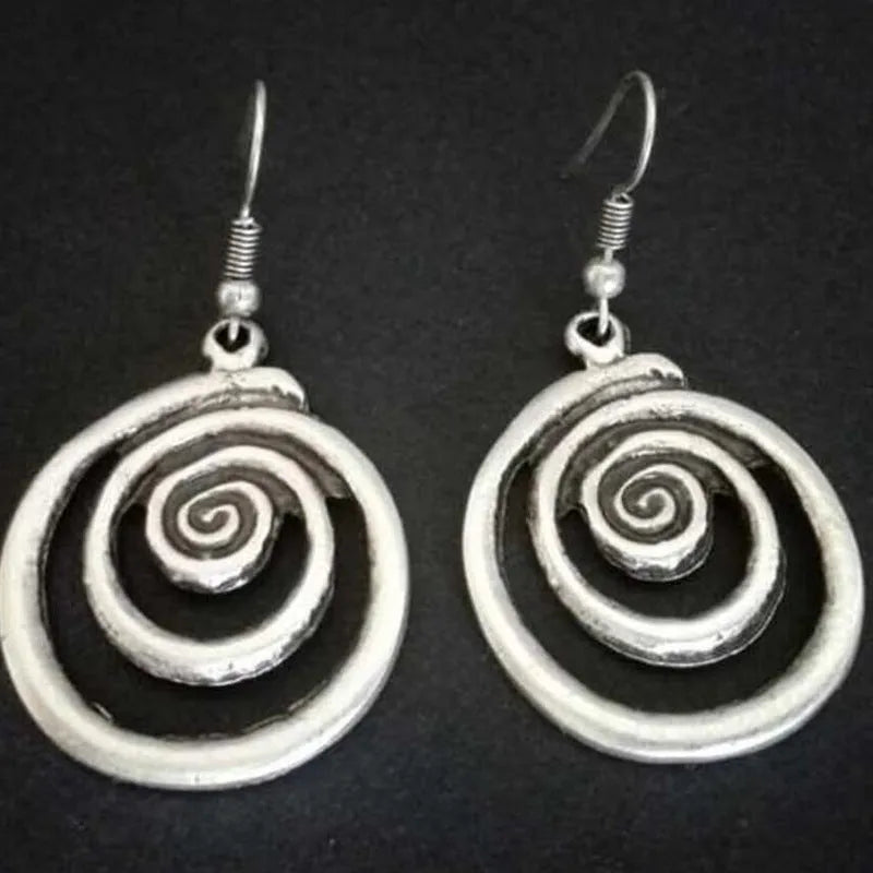 Retro geometric spiral earrings with a distressed silver finish.