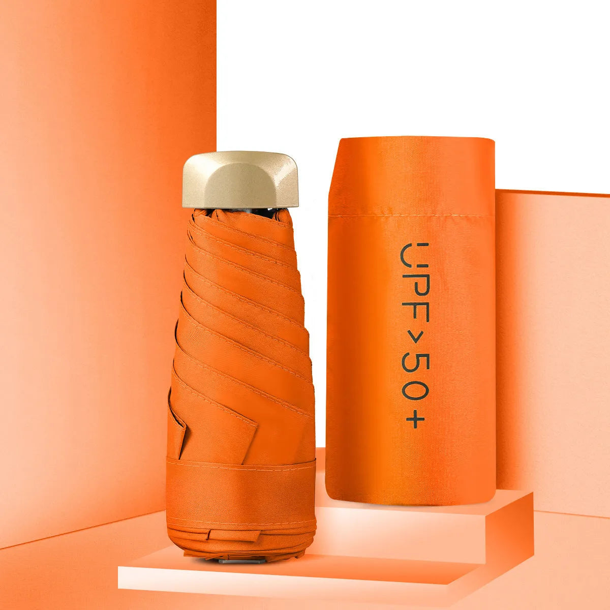 Compact flat-folded sun umbrella in a solid colour, shown next to a hand for scale.