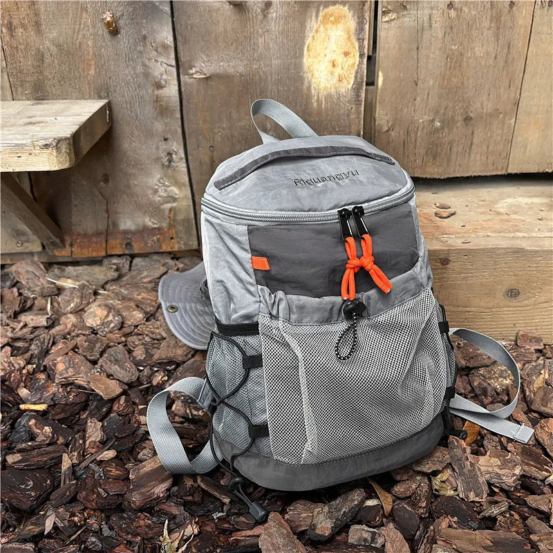 Waterproof nylon casual backpack in blue with curved shoulder straps and fold details
