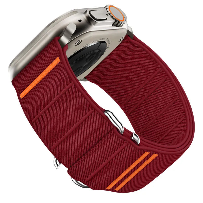 Elastic nylon Apple Watch band with stainless steel buckle shown in Army Green colour on a wrist.