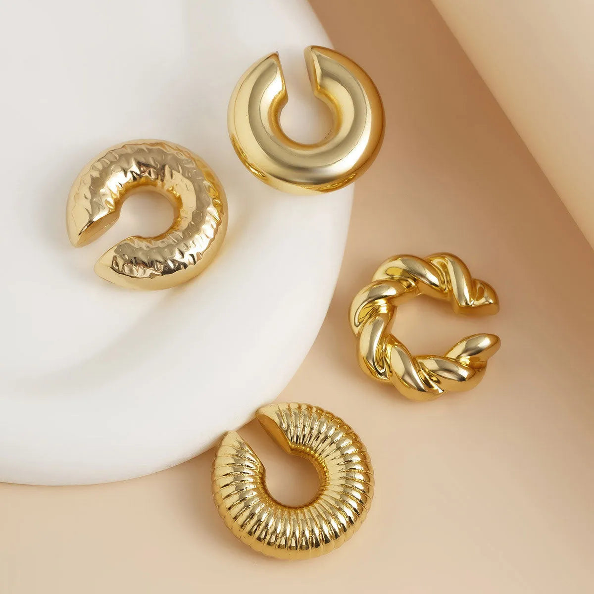 A set of four geometric-shaped clip-on earrings for women in gold or silver ccb.