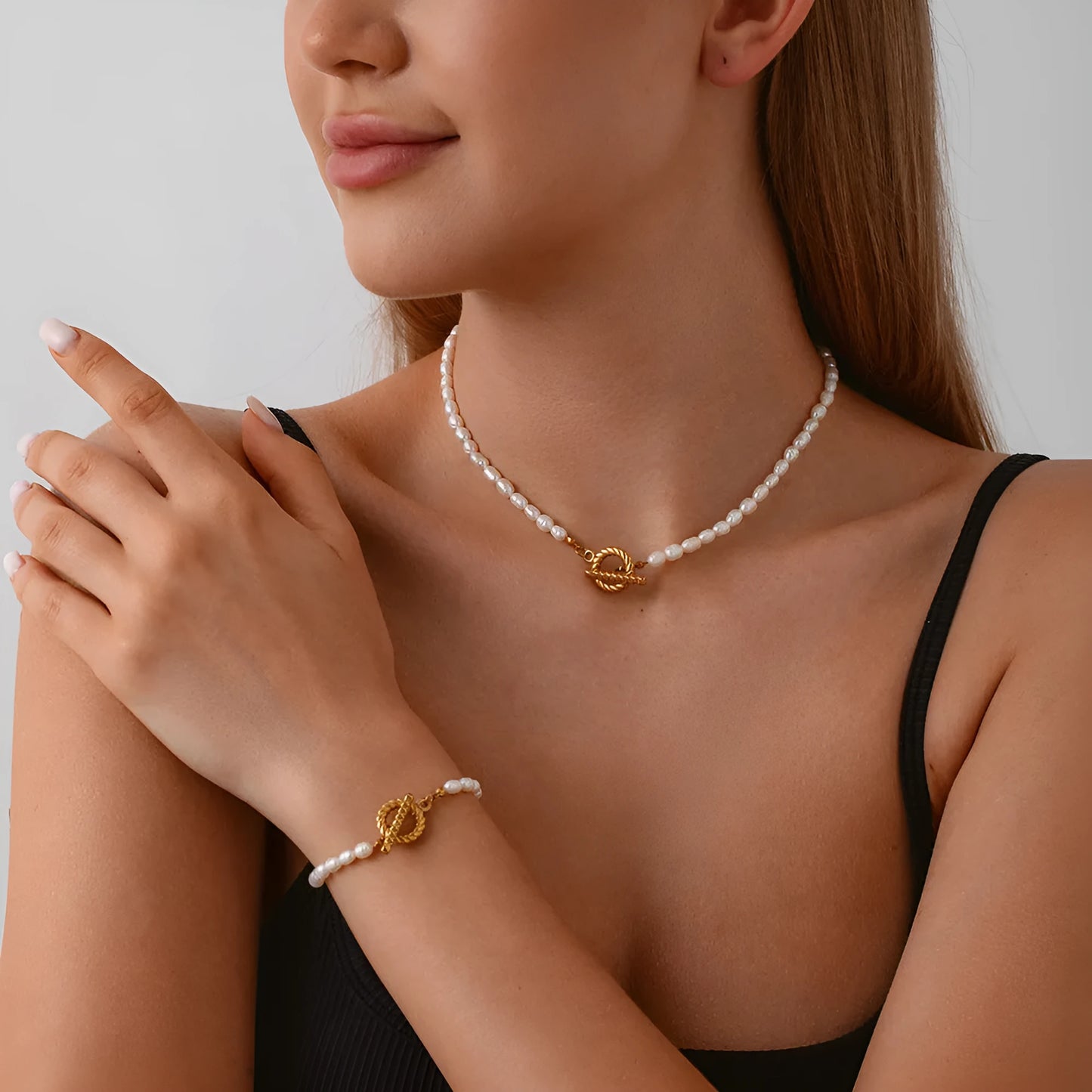Freshwater pearl and stainless steel geometric pendant necklace with matching bracelet set.