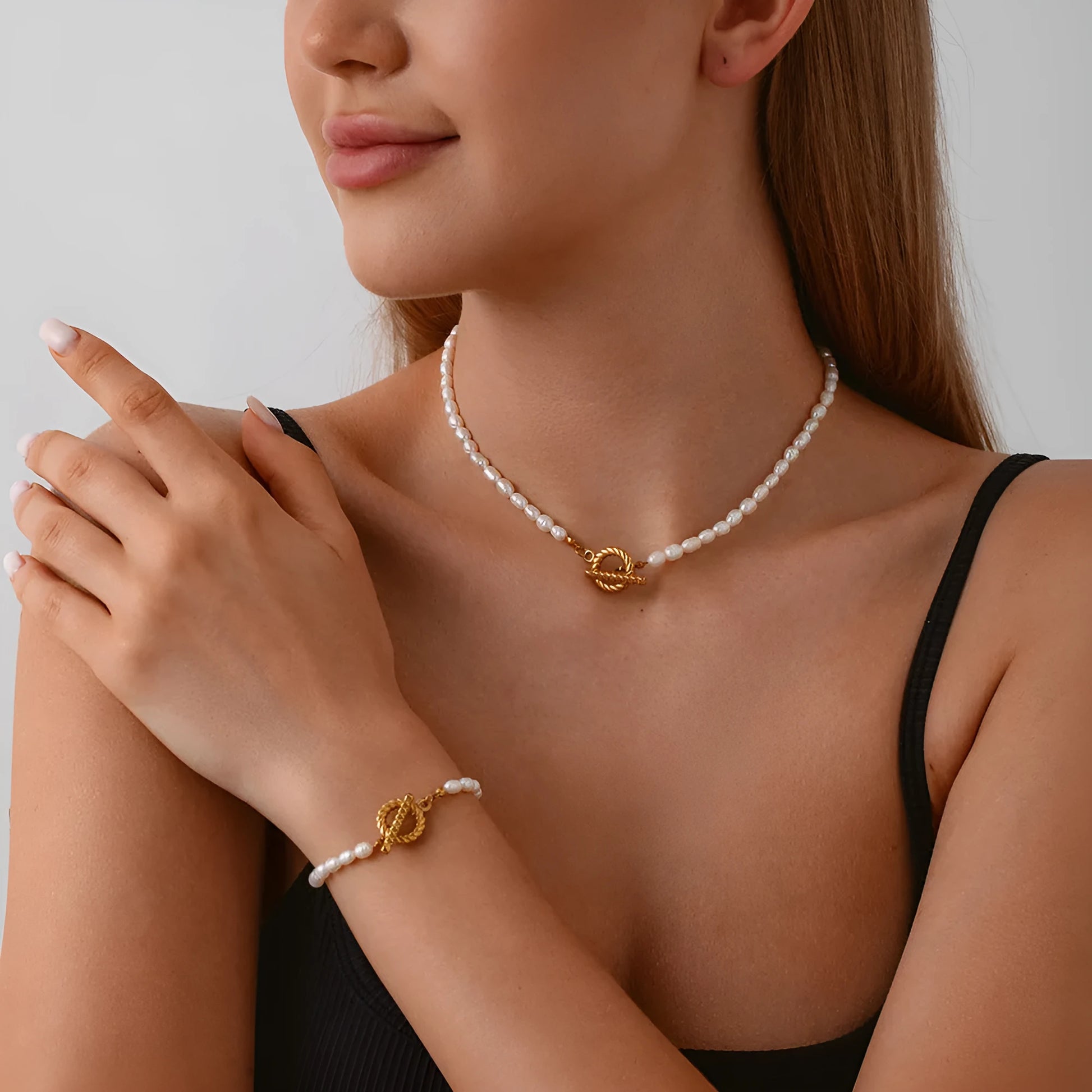 Freshwater pearl and stainless steel geometric pendant necklace with matching bracelet set.