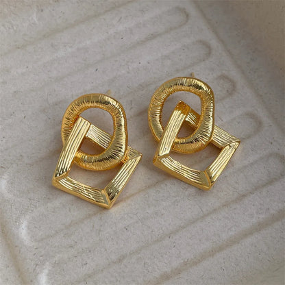 Copper geometry circle pendant earrings with electroplated gold finish measuring 3.4cm in height