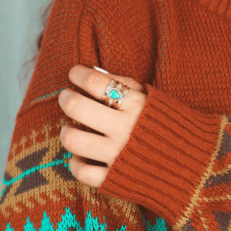 Retro green pine three-colour alloy ring for men and women on a plain background.