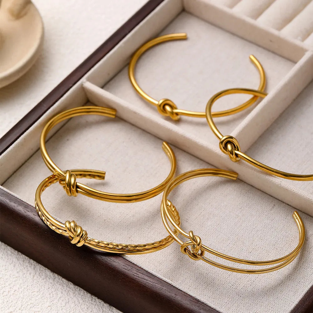 Stainless steel women's bracelet with knotted C-shape open double-layer design in gold or silver.