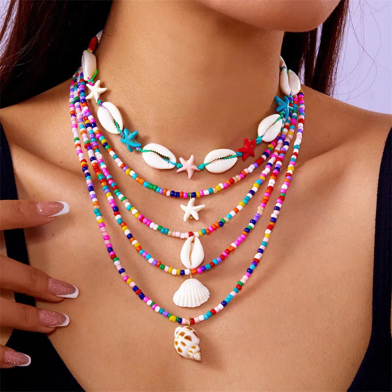Five women's necklaces with starfish shell beads on adjustable chains in summer colours