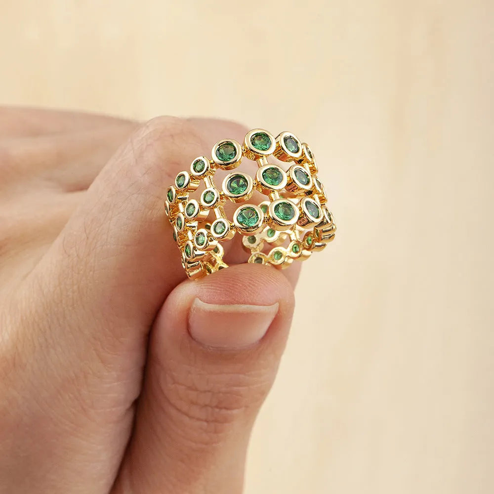 Wide gold-plated copper ring with three-layer design and a large green zircon stone.