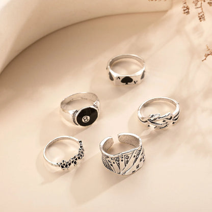 Black adjustable ring with a raised polished spade card suit motif on a wide band.