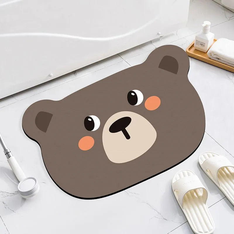 Alien-shaped diatomaceous earth bathroom mat with a cartoon hippo design on a tiled floor.