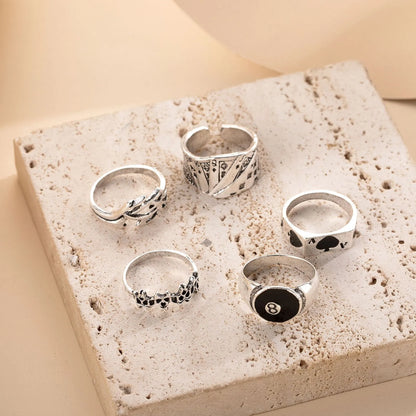 Black adjustable ring with a raised polished spade card suit motif on a wide band.