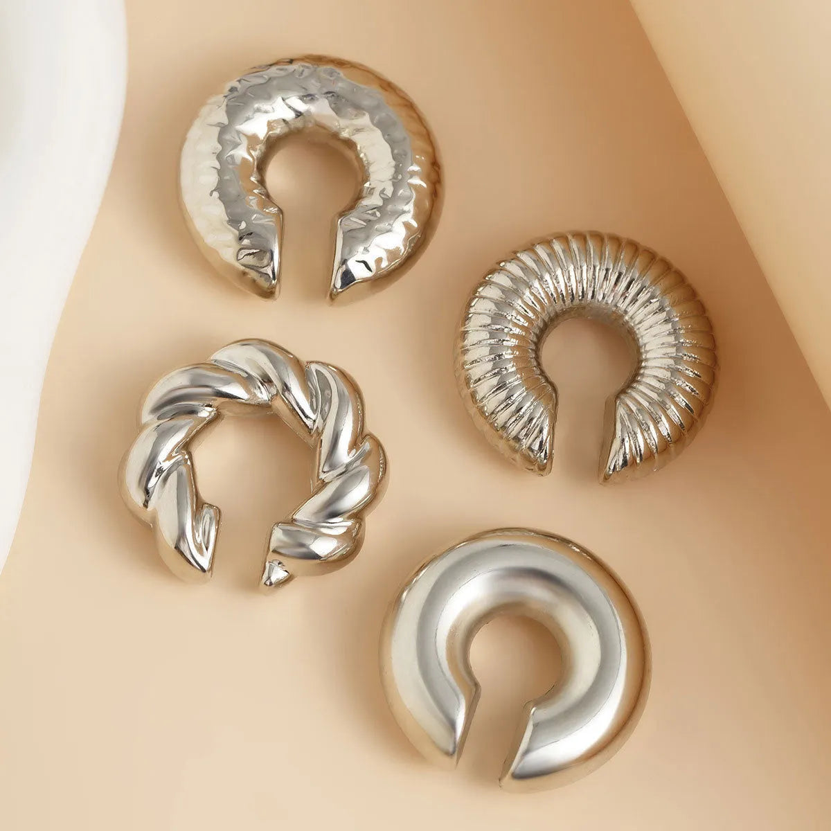 A set of four geometric-shaped clip-on earrings for women in gold or silver ccb.