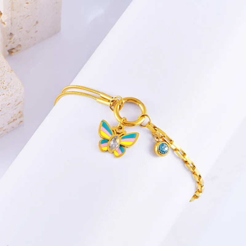 Gold-coloured titanium steel butterfly necklace and matching bracelet set on a snake bone chain.
