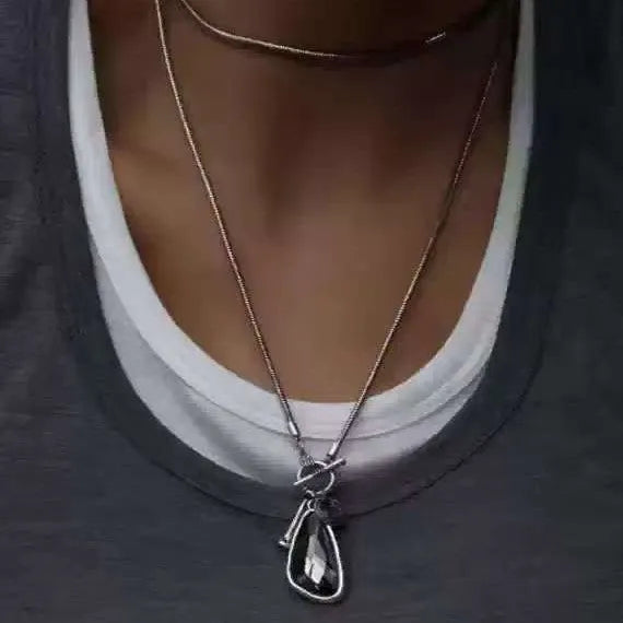Women's geometric alloy pendant on a long snake bone chain necklace in blue, champagne, or grey.