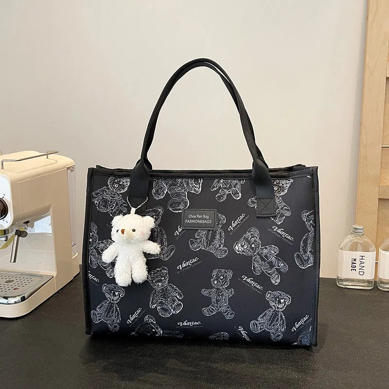 Women's black and white soft canvas tote bag with large capacity and printed rhombus pattern on front.