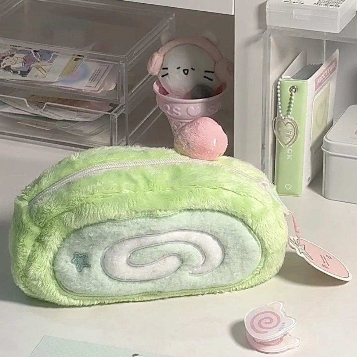 Honeydew Roll Plush velvet pencil case with Swiss roll cake design, showing roll-up style and soft texture for stationery storage.