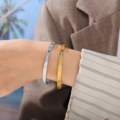 Stainless steel open-end bracelet with a buckle clasp in a choice of gold, silver, or zirconium gold electroplated finishes.