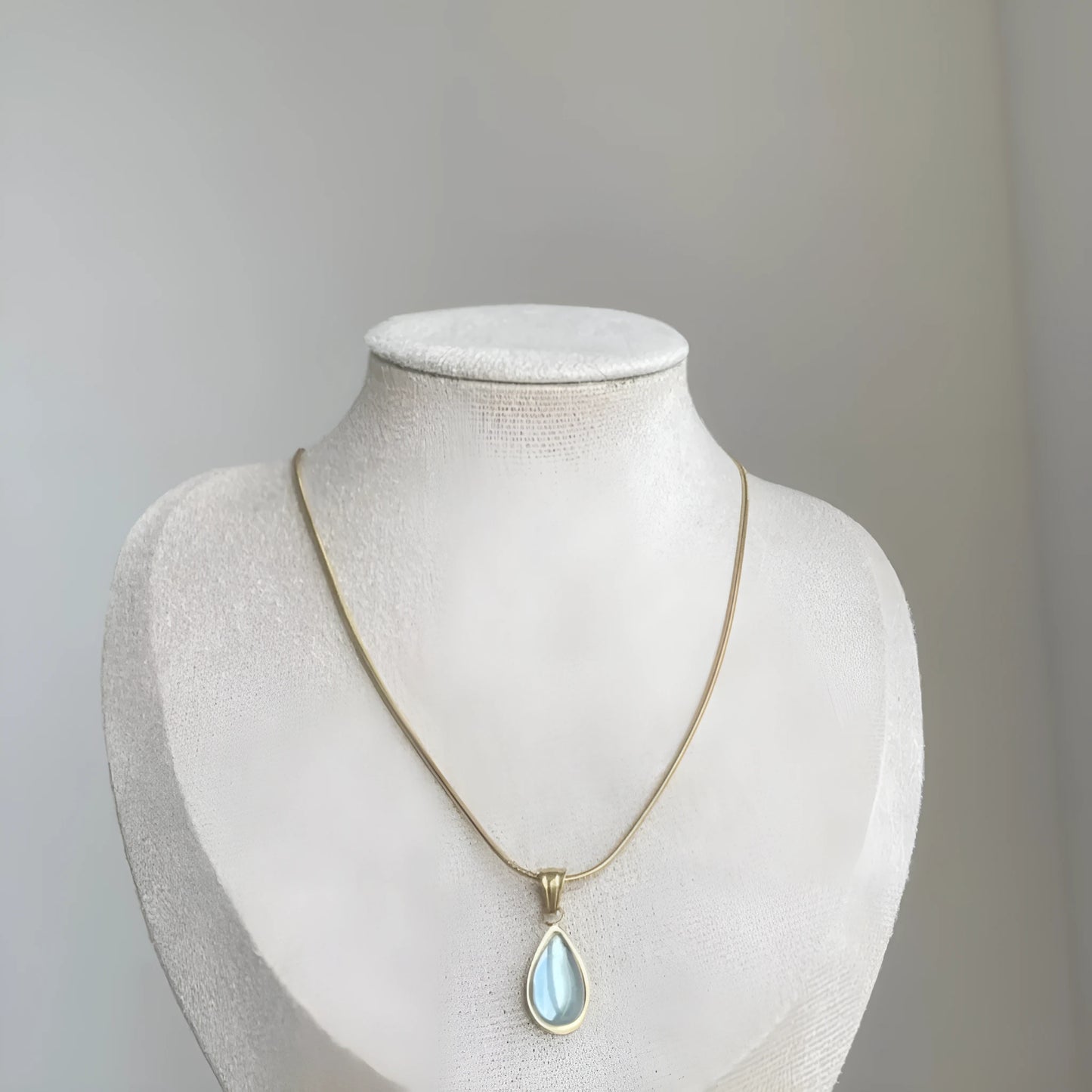 Retro blue and green water drop necklace with gem inlay on a silver titanium steel snake chain.