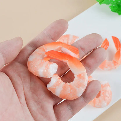 White PVC shrimp-shaped keychain with door buckle on a blue background.