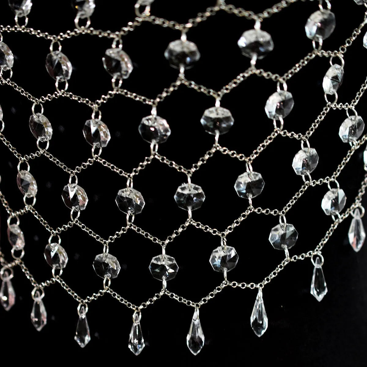 Clear acrylic crystal sequins body chain draped as a chest necklace.