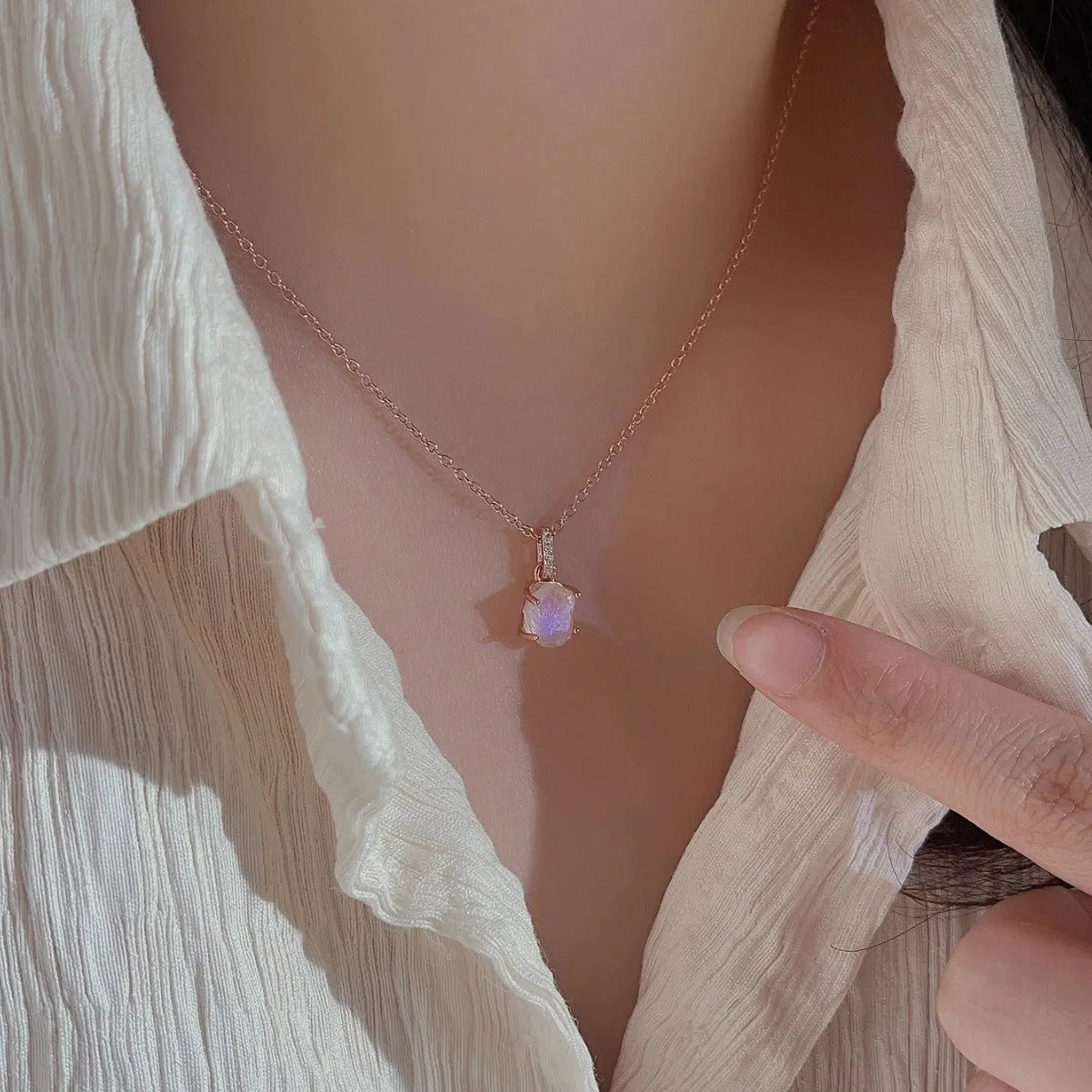 Geometric crystal moonstone pendant on an adjustable sterling silver necklace chain.