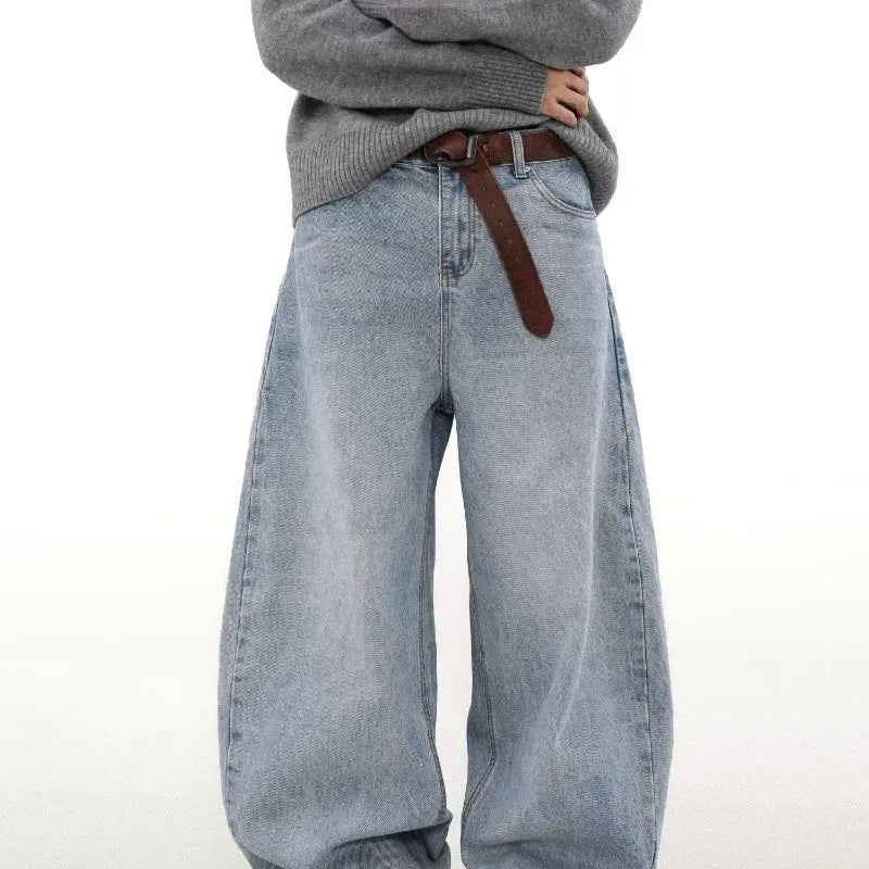Man wearing retro blue washed straight leg distressed jeans with a mid-rise waist.