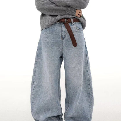 Man wearing retro blue washed straight leg distressed jeans with a mid-rise waist.