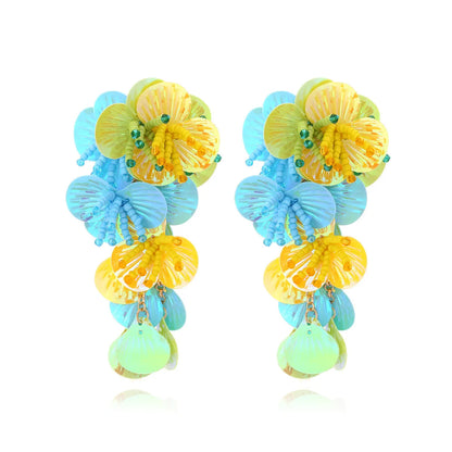 Handmade string bead flower earrings with exaggerated floral shapes in rose and purple colours, showing mixed materials and nickel-free hooks