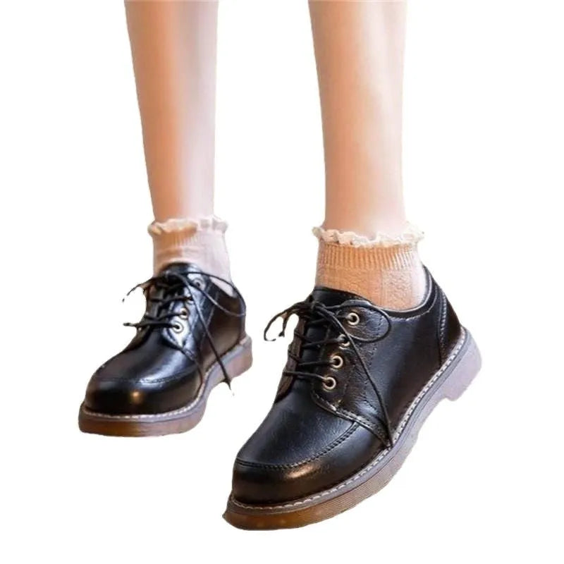 Black retro women's Mary Jane shoes with lace-up front and low square heel on a white background.