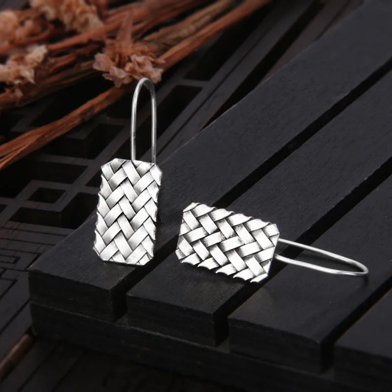 Pair of 925 silver geometric stud earrings with a woven diamond plaid texture on a white background.