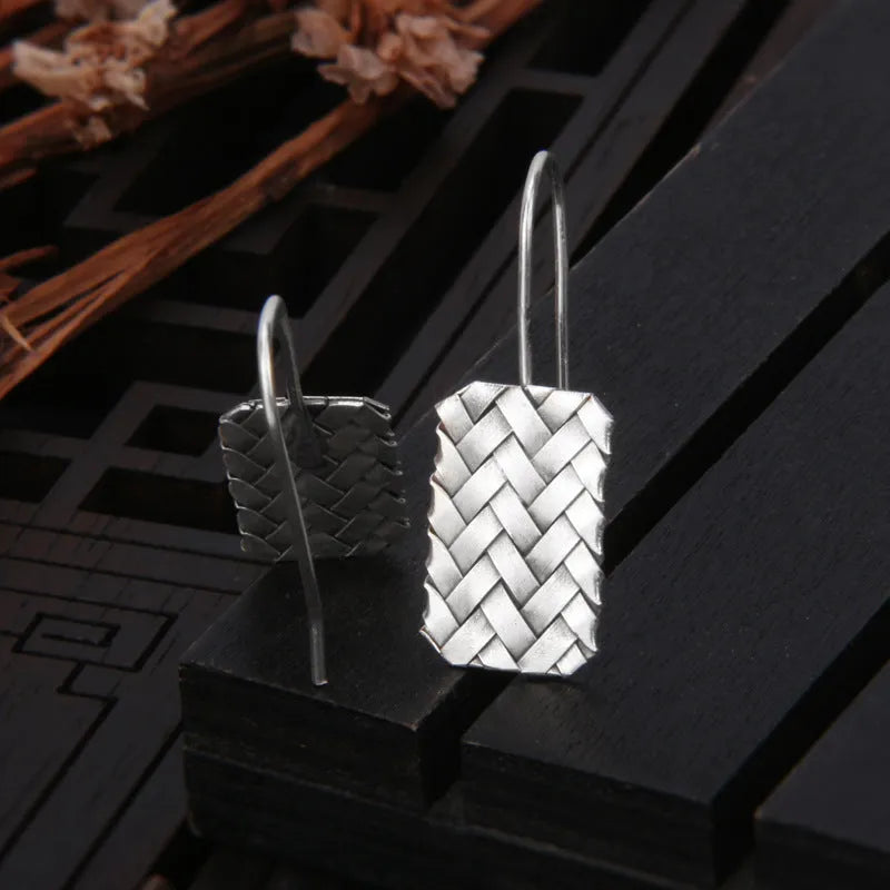 Pair of 925 silver geometric stud earrings with a woven diamond plaid texture on a white background.
