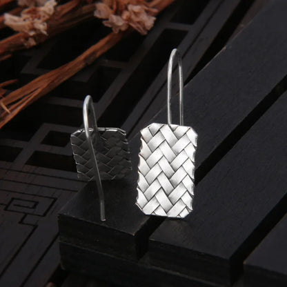 Pair of 925 silver geometric stud earrings with a woven diamond plaid texture on a white background.