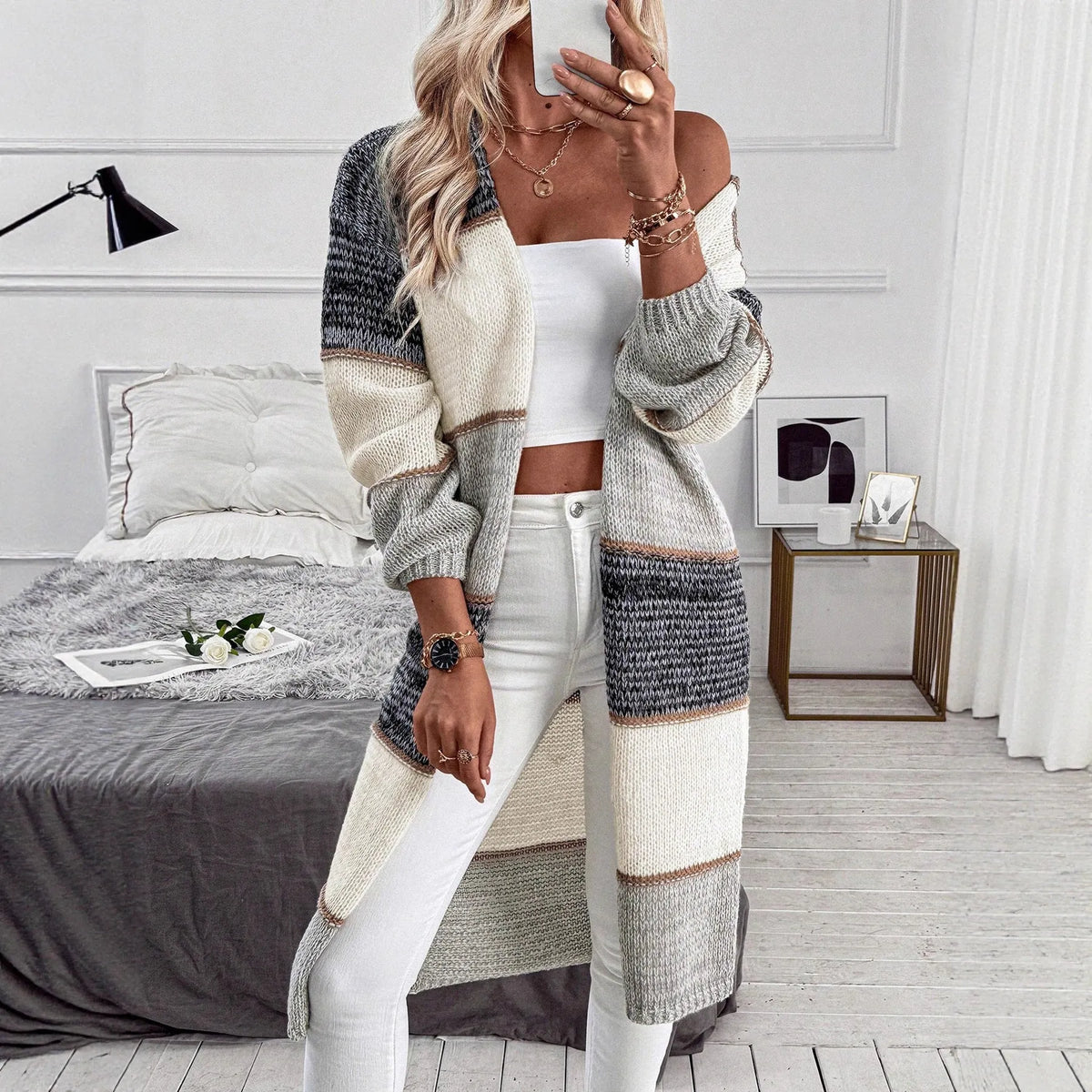 Grey loose-fit women's knitted cardigan with long sleeves and a striped plaid pattern.
